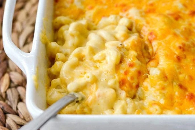 Creamy macaroni and cheese with a golden cheese topping in a baking dish.