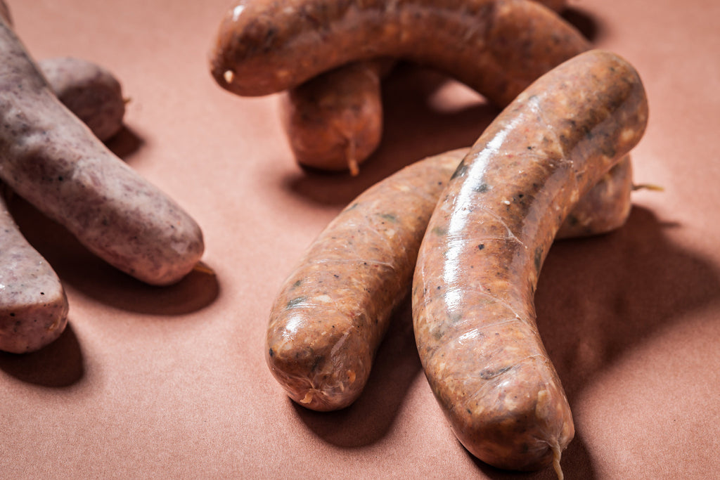 Assorted sausages on a textured surface