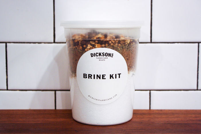 Container of brine kit with a label on a wooden surface