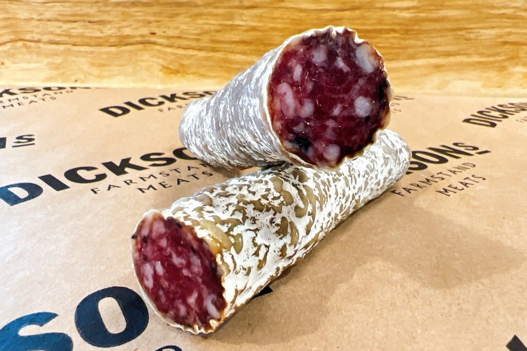 Two pieces of cured meat on branded packaging